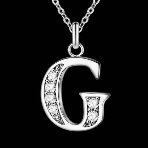 Silver letter 'G' pendant with crystals on a chain, isolated on a black background