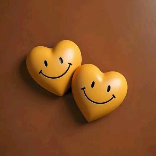 Two yellow heart-shaped objects with smiley faces on a brown background