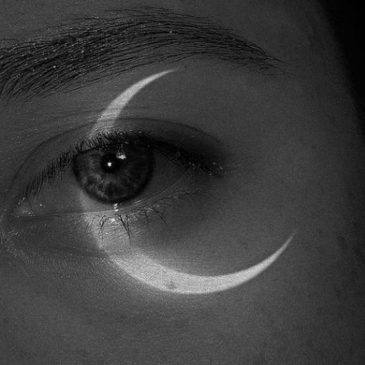 a close up of a person's eye with a crescent