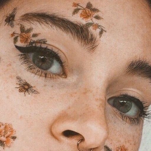 a close up of a woman with flowers on her face