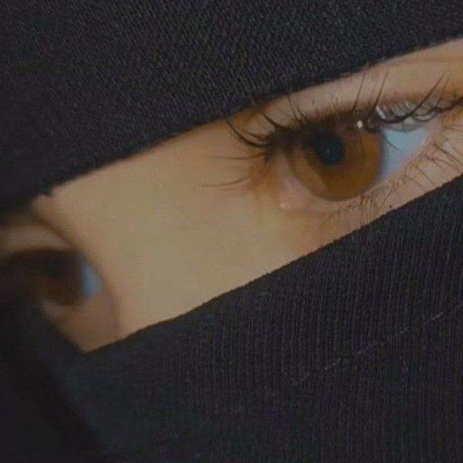 a close up of a woman's eye wearing a black veil