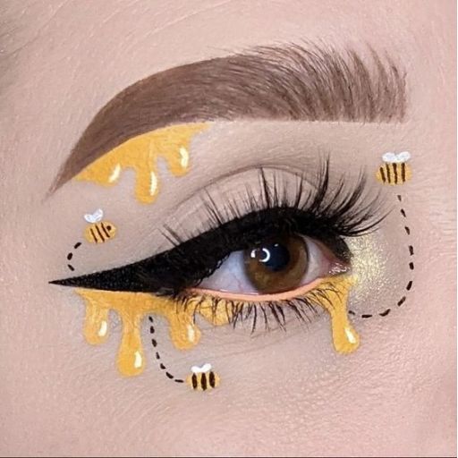 a close up of a woman's eye with bees on it