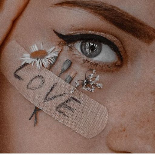 a close up of a woman's face with a tag with the word love