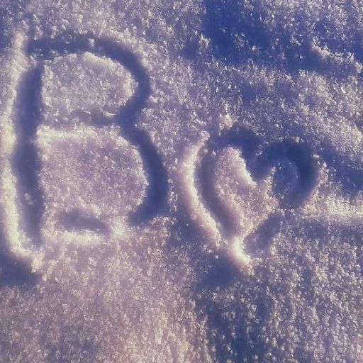 a close up of the word go written in the snow