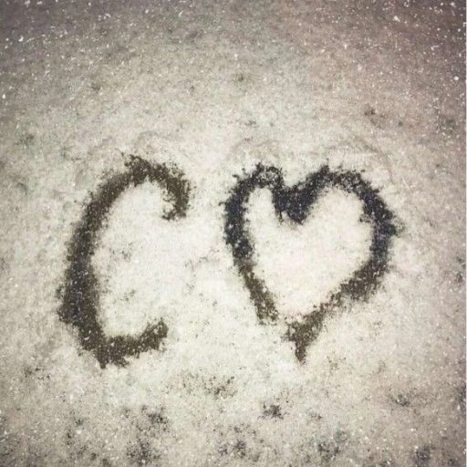 a couple of hearts drawn in the snow