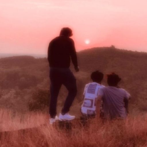 a couple of people standing on top of a hill