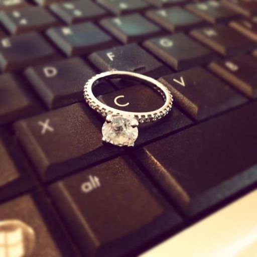 a diamond ring sitting on top of a computer keyboard