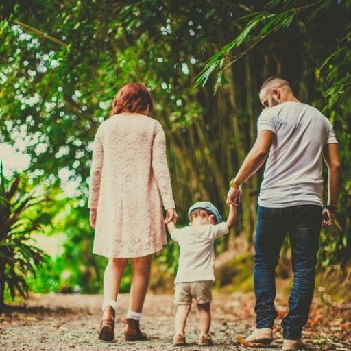 a family walking down a path in the woods