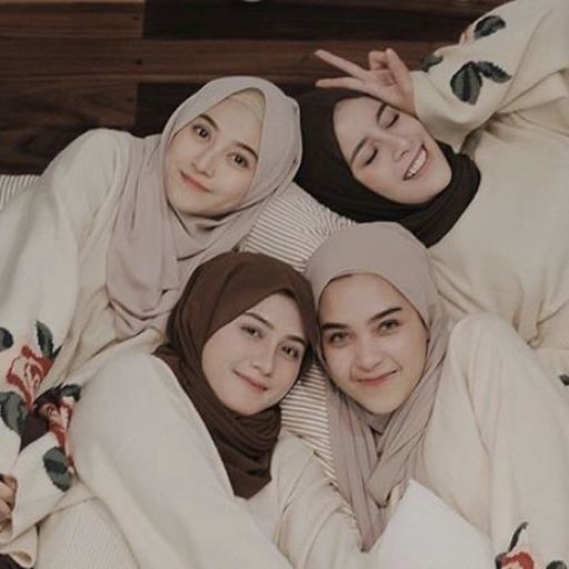 a group of women laying on top of a bed