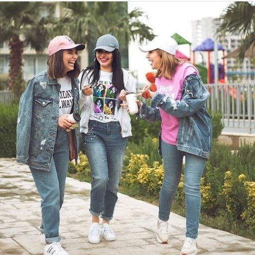 a group of young women walking down a sidewalk