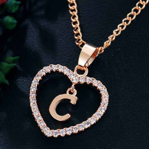 a heart shaped necklace with a letter on it