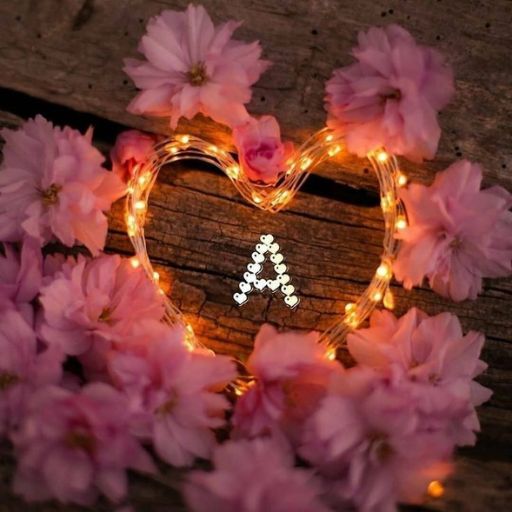 a heart shaped wreath with flowers around it