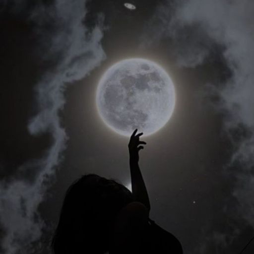 a person reaching up to the moon in the sky