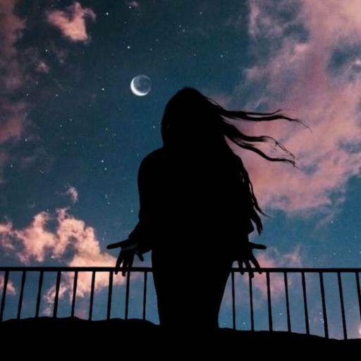 a person standing on a balcony looking at the sky