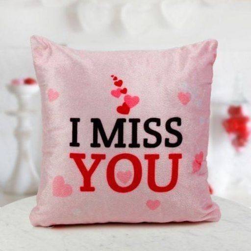 a pink pillow that says i miss you