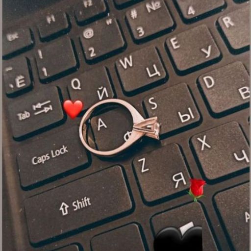 a red rose sitting on top of a computer keyboard