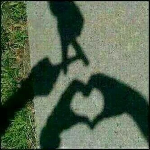 a shadow of two hands making a heart