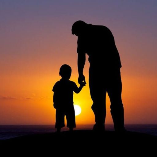 a silhouette of a man holding the hand of a child