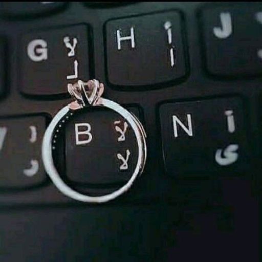 a wedding ring sitting on top of a computer keyboard