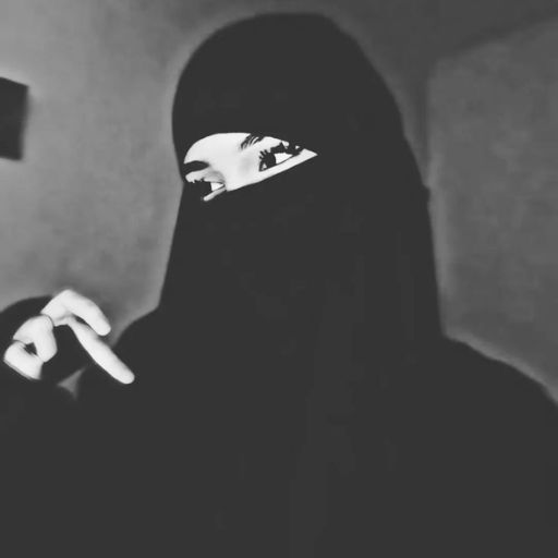 a woman in a black hijab holding a cell phone