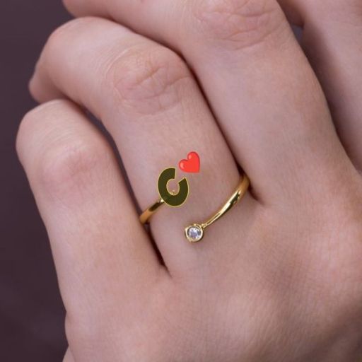 a woman's hand with a gold ring with two hearts on it