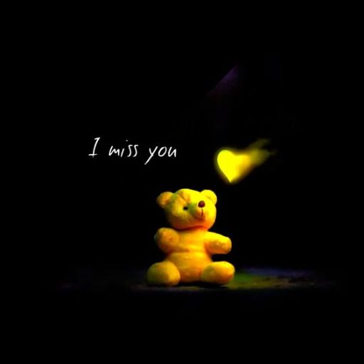 a yellow teddy bear sitting in the dark