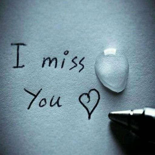 i miss you written on a piece of paper next to a pen