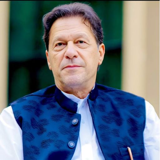 A person in a blue waistcoat over a white shirt against a blurred background