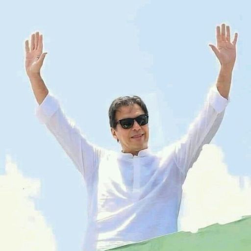 Person in a white shirt raising their arms against a sky background