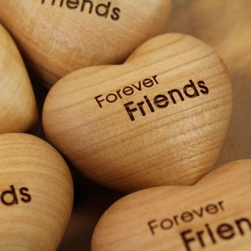 Wooden hearts inscribed with _Forever Friends_ on a close-up view