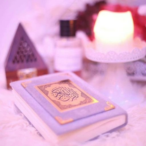 A closed book with Arabic script on the cover, surrounded by soft lighting and warm decor elements