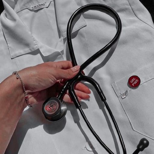 A hand holding a black stethoscope on a white lab coat, with selective color highlighting red elements