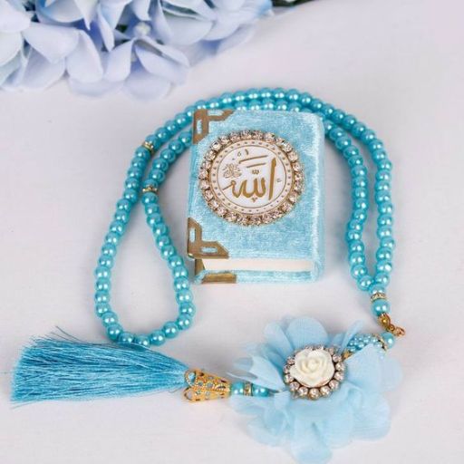 A turquoise prayer bead set with a matching tasseled Quran book and flower clip