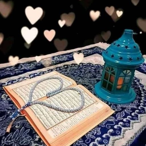 An open book with a heart-shaped rosary on it and a lit teal lantern, against a background with heart bokeh