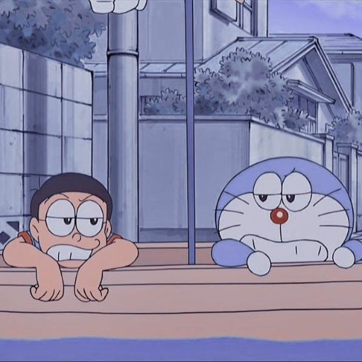 Animated boy and a blue robotic cat lying on their stomachs on the ground in a suburban setting