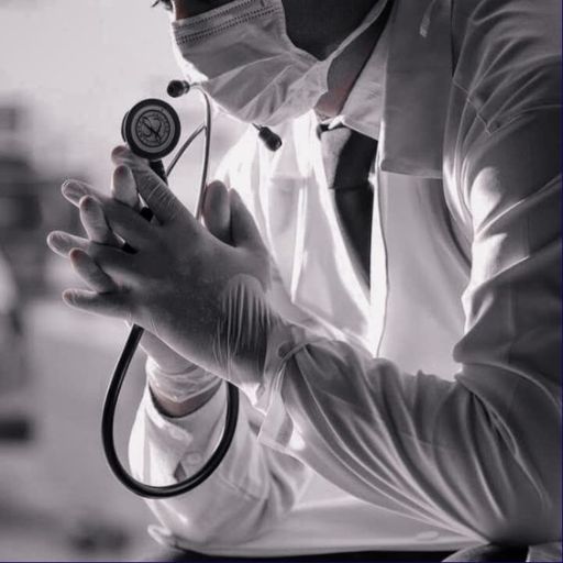 Healthcare professional in white lab coat holding a stethoscope