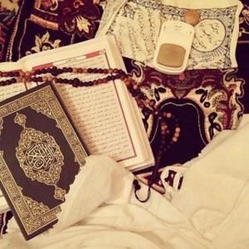 Islamic prayer items including a Quran, prayer beads, and a prayer rug