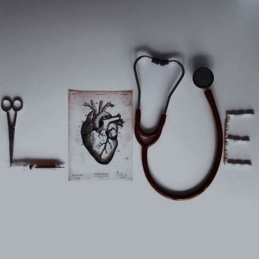 Stethoscope and medical tools arranged to spell _LOVE_ with a heart drawing