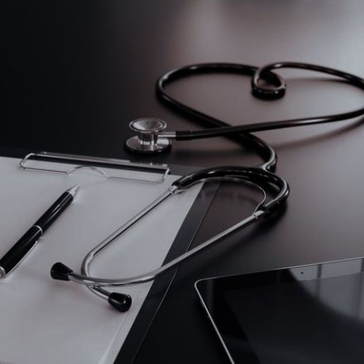 Stethoscope shaped like a heart on a desk with paper, pen, and tablet, symbolizing healthcare