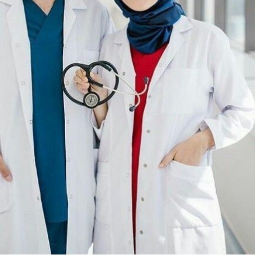 Two medical professionals in white lab coats, one wearing a stethoscope and hijab