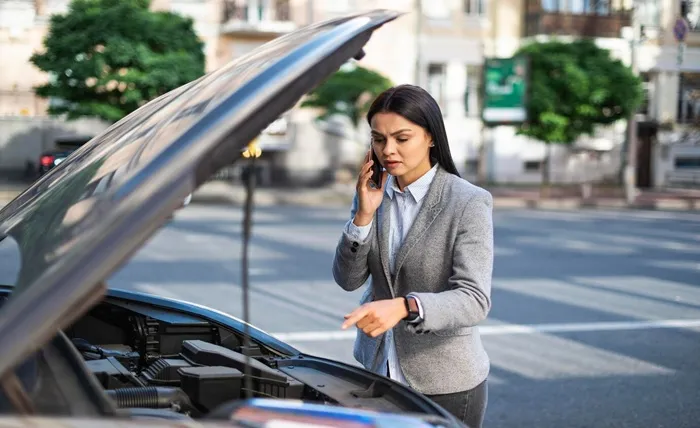 businesswoman talking phone while her car broke down 23 2148766980