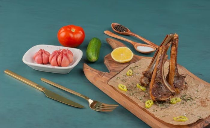 How is a crown rack of lamb prepared for roasting and presentation?